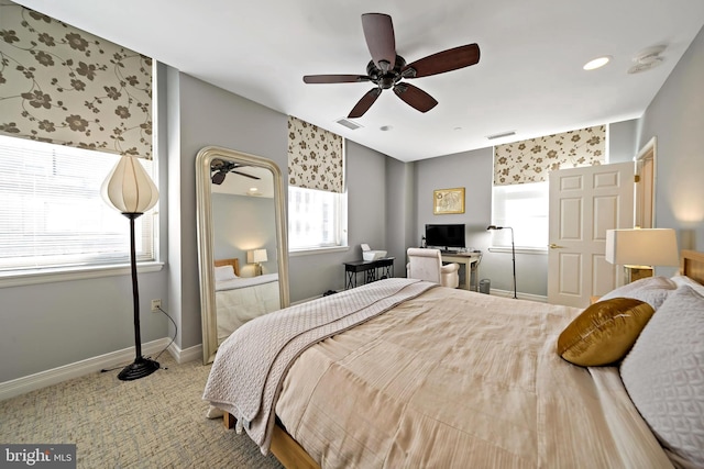 carpeted bedroom with visible vents, ceiling fan, and baseboards