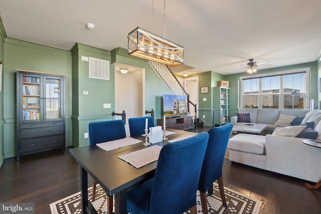 dining space with stairs, visible vents, dark wood-style flooring, and crown molding