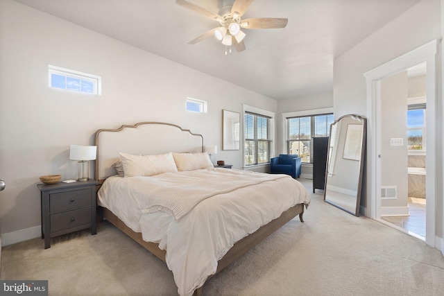 bedroom with visible vents, baseboards, light colored carpet, and ceiling fan