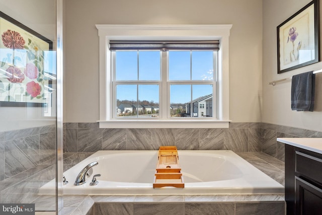 bathroom featuring vanity and a garden tub