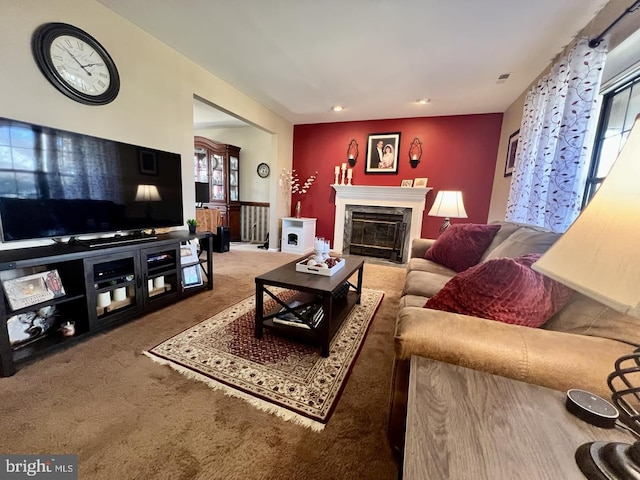 living room featuring carpet flooring, visible vents, and a high end fireplace