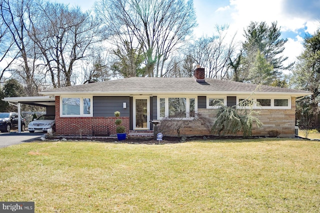 single story home with driveway, a front yard, a carport, and a chimney