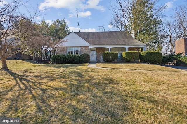 view of front of property featuring a front yard and stone siding