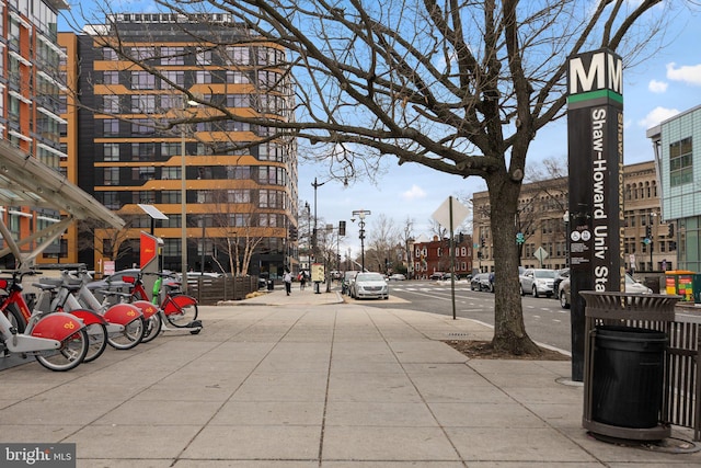 view of street featuring sidewalks, street lights, and traffic signs