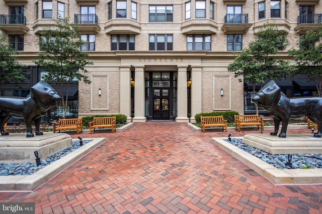 property entrance featuring french doors and brick siding