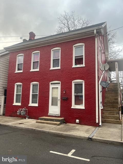 view of front of house with entry steps and brick siding