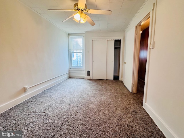 unfurnished bedroom with a closet, ceiling fan, baseboards, and carpet floors