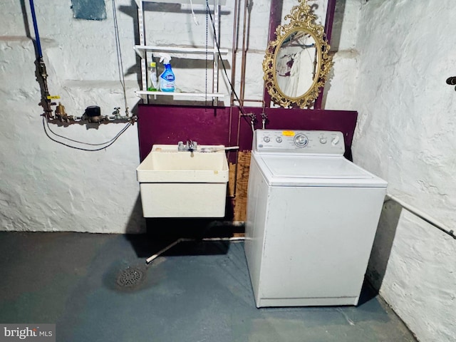 clothes washing area featuring washer / dryer, laundry area, and a sink