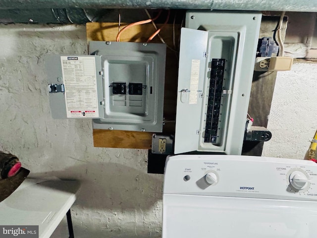 utility room with electric panel and washer / clothes dryer