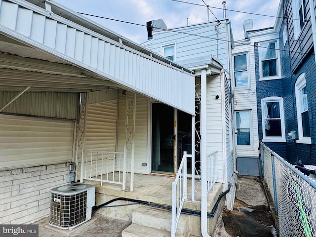 exterior space with a patio area, central AC unit, and fence