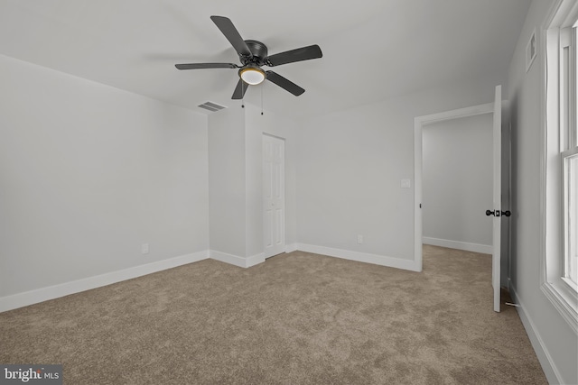 interior space with baseboards, visible vents, and carpet flooring