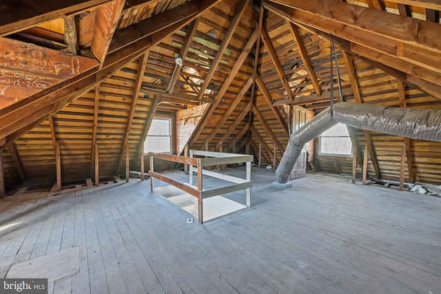 unfinished attic featuring an upstairs landing