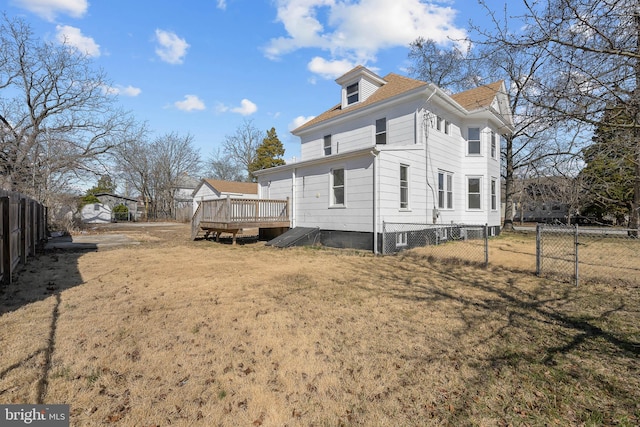 view of property exterior featuring a yard, fence, and a deck