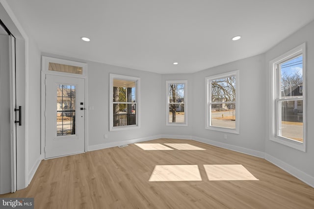 entryway with light wood-style floors, recessed lighting, and a healthy amount of sunlight