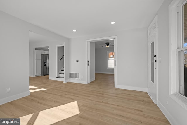 empty room with recessed lighting, visible vents, baseboards, stairs, and light wood finished floors