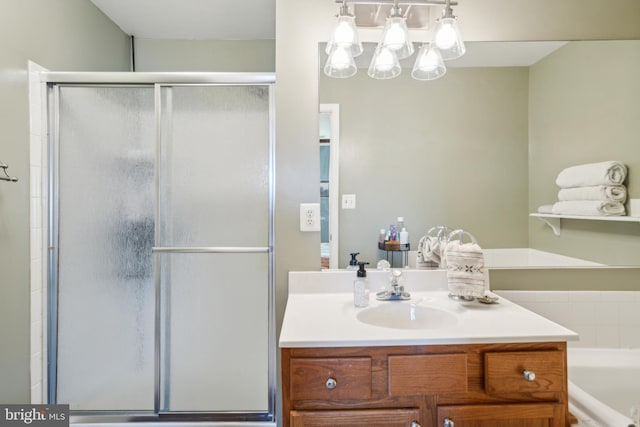 full bath featuring a shower stall, vanity, and a tub to relax in