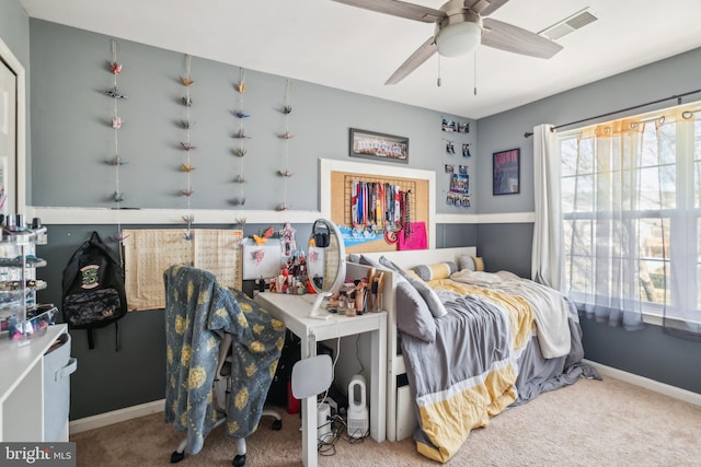 bedroom featuring visible vents, baseboards, carpet, and a ceiling fan