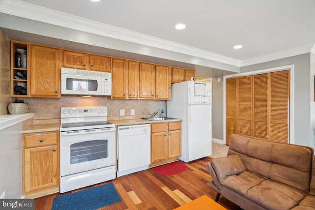 kitchen with white appliances, crown molding, wood finished floors, and light countertops