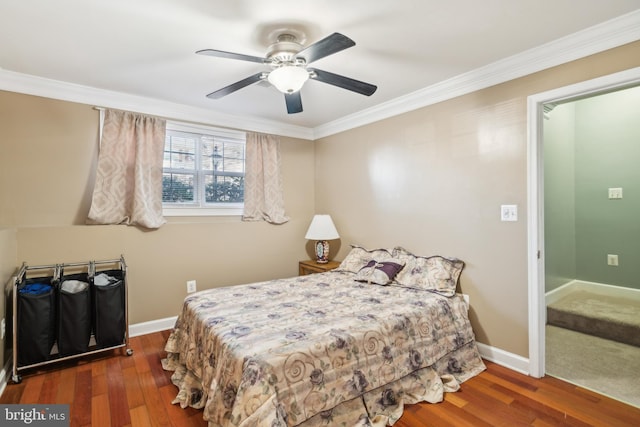 bedroom with crown molding, baseboards, and wood finished floors