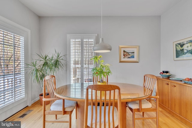 dining space with visible vents and light wood-type flooring