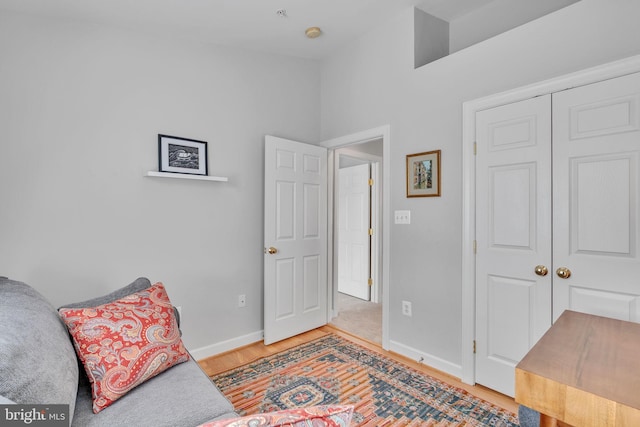 sitting room featuring baseboards and light wood-style floors