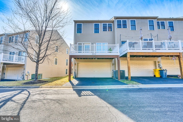 view of property featuring an attached garage and driveway