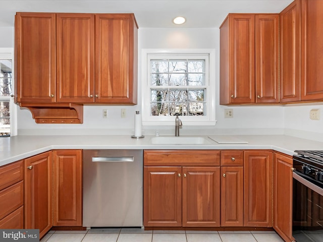 kitchen with brown cabinets, a sink, black gas range oven, light countertops, and dishwasher