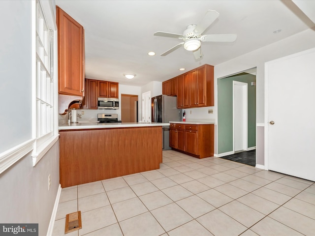 kitchen with visible vents, ceiling fan, light countertops, appliances with stainless steel finishes, and a peninsula