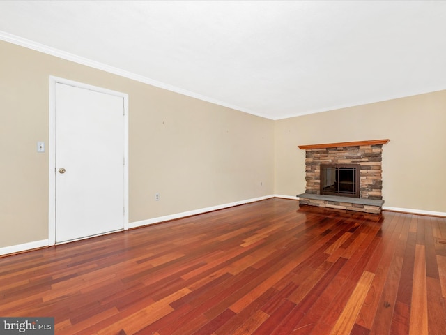 unfurnished living room featuring baseboards, ornamental molding, a fireplace, and hardwood / wood-style flooring