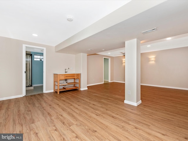 finished below grade area with baseboards, visible vents, light wood finished floors, recessed lighting, and ceiling fan