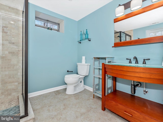 full bath with a wealth of natural light, baseboards, toilet, and a shower stall