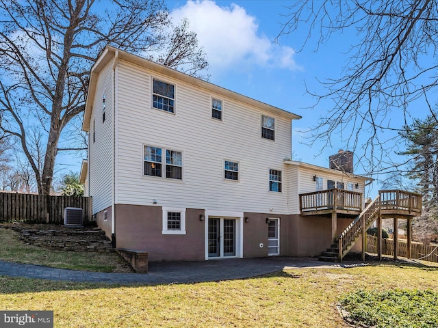 back of property featuring stairs, fence, french doors, and a wooden deck