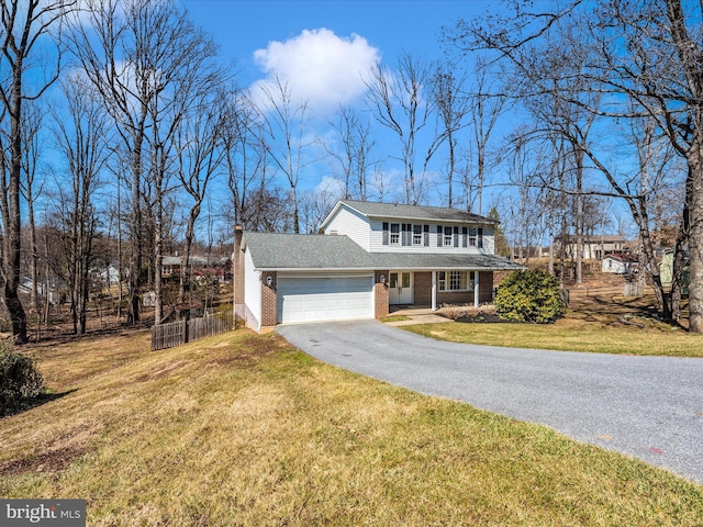 view of front of property with a front yard, fence, a garage, aphalt driveway, and brick siding