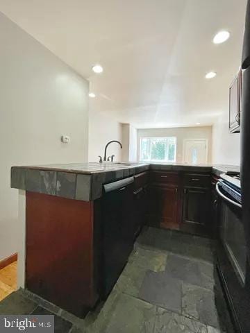 kitchen featuring black appliances, a sink, and recessed lighting