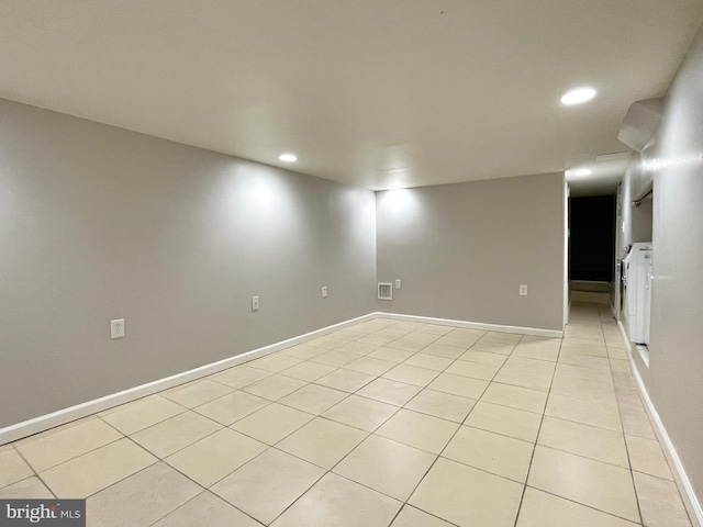 empty room featuring light tile patterned floors, recessed lighting, visible vents, baseboards, and washer and clothes dryer