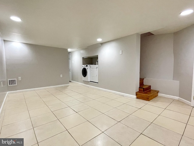 finished below grade area with washer and clothes dryer, light tile patterned flooring, visible vents, and recessed lighting