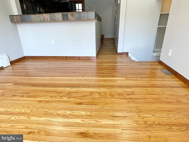 kitchen with visible vents, baseboards, and wood finished floors