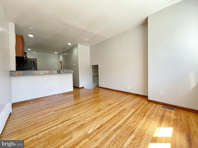 unfurnished living room featuring light wood-style floors, baseboards, visible vents, and recessed lighting