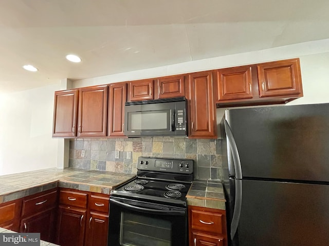 kitchen with tasteful backsplash, tile countertops, and black appliances