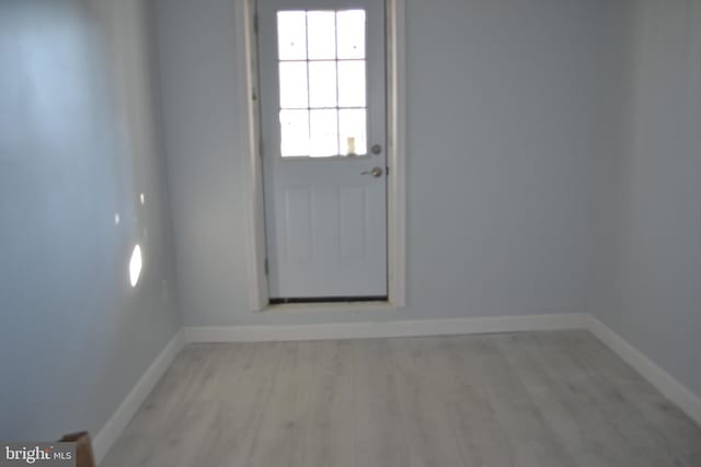 entryway featuring light wood-style floors and baseboards