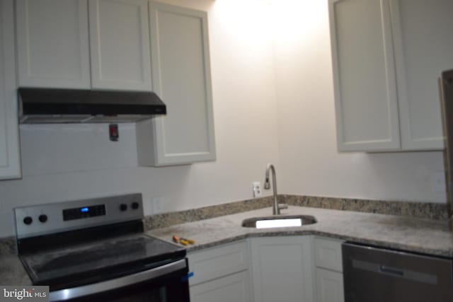 kitchen with light countertops, a sink, range with electric cooktop, dishwasher, and under cabinet range hood