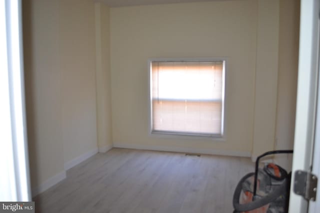 unfurnished room featuring baseboards and wood finished floors