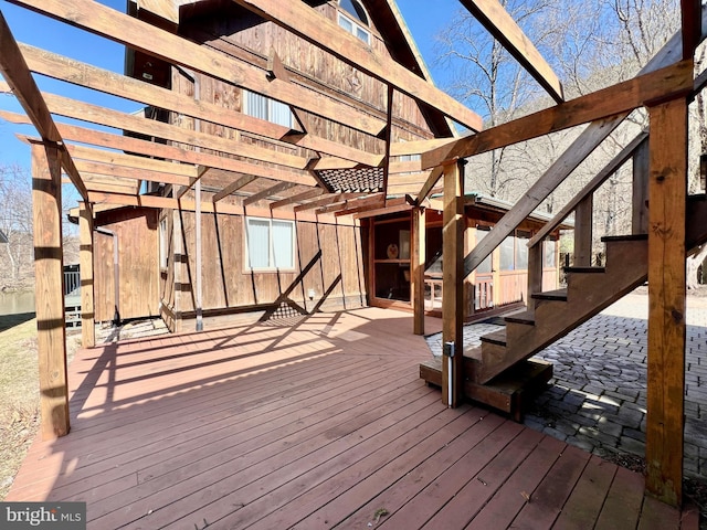 deck with stairs and a pergola