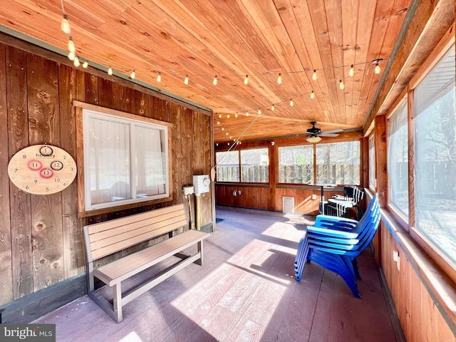 sunroom / solarium with lofted ceiling, rail lighting, and wood ceiling