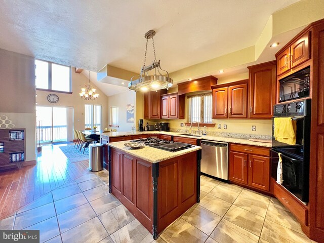 kitchen with light tile patterned floors, black appliances, a peninsula, and a sink