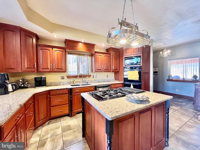 kitchen featuring light stone counters, light tile patterned floors, a kitchen island, a sink, and black appliances