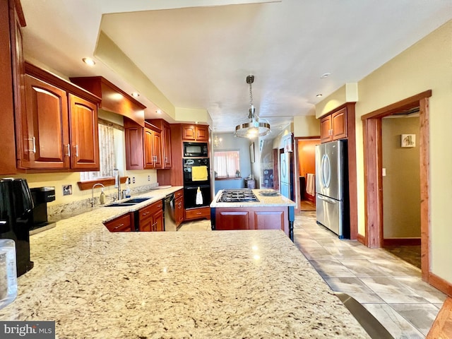 kitchen with a peninsula, a sink, baseboards, black appliances, and pendant lighting