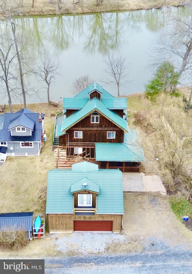 view of front of home featuring gravel driveway and a water view