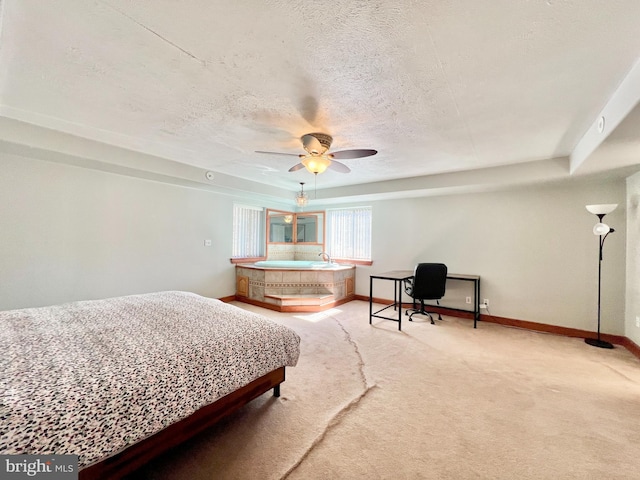 bedroom with light colored carpet, ceiling fan, a textured ceiling, and baseboards