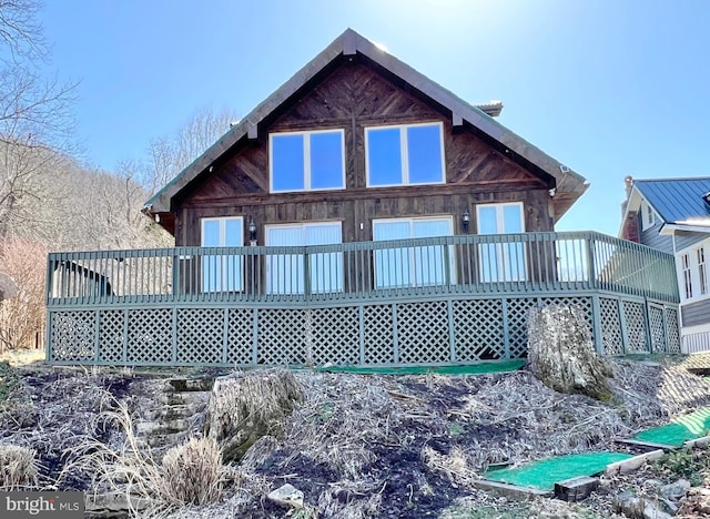 back of house with a wooden deck